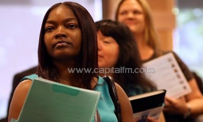 Job seekers line up to meet with a recruiter during a job fair/AFP