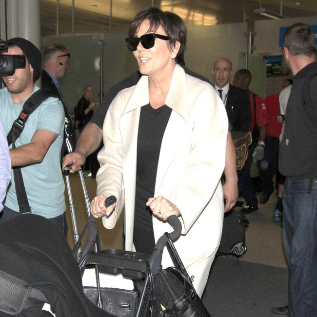 Kris Jenner returns to Los Angeles pushing baby North West after attending daughter, Kim Kardashian's wedding