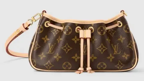 Louis Vuitton A brown Louis Vuitton handbag with the company's iconic graphics, including the four-petal flower monogram, printed across the leather