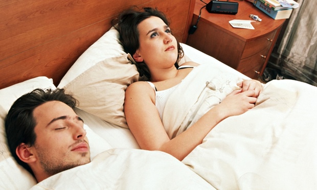 Man asleep and young woman sleeplessness