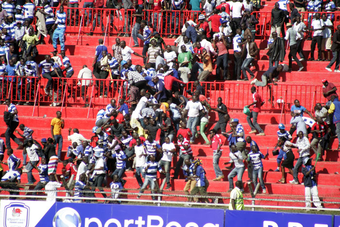 AFC Leopards fans flee tear gas during a past Mashemeji Derby. PHOTO/Raymond Makhaya