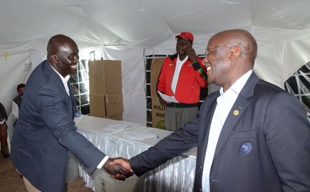 Nondescript chairman Thomas Opiyo greeting KRU boss Richard Omwela after being declared winner of the vice chairman seat.PHOTO/Timothy Olobulu