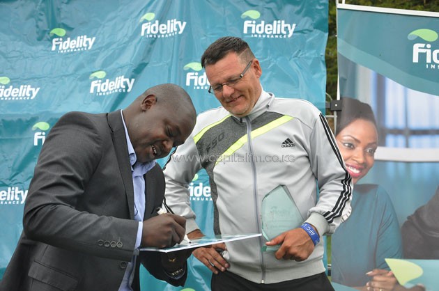 Fidelity Insurance marketing manager Nicholas Malesi (left) signing a cheque for AFC Leopards head coach Ivan Minnaert who was named coach of the month for March.PHOTO/SJAK