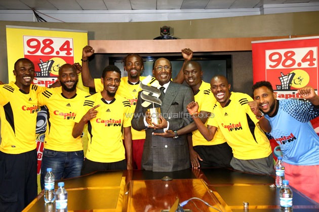The triumphant Capital FM team presents the Road to Anfield trophy to Capital Group Limited Chairman Dr Chris Kirubi/PHOTO-Susan Wong