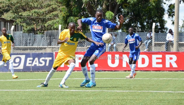 Mathare United's John Mwangi vies for the ball with Posta's Rashid Mayaka.PHOTO/Timothy Olobulu