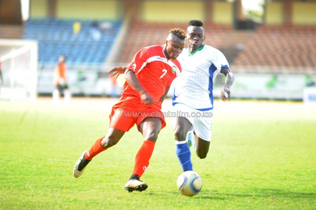 Harambee Stars winger Ayub Timbe past Taifa Stars' Mohammed Hussein.PHOTO/Raymond Makhaya.