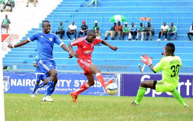 Posta Rangers' Cavin Odongo in action as he is closed on by City Stars captain John Amboko during their SPL match.PHOTO/Timothy Olobulu.