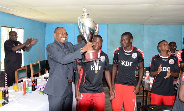 Ulinzi Stars chairman Col JS Mwinyikai receives the KPL U-20 trophy.PHOTO/Timothy Olobulu.