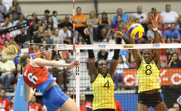 Kenya's Esther Wangeci (left) and Triza Atuka (right) go for a block against a Puerto Rico attacker. Atuka won ten blocks- PHOTO/Dennis Machio-KVF